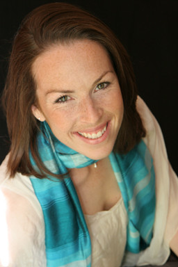 Jessie Richings, smiling, wearing an aqua scarf